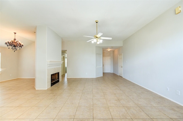 19814 Lindenfield Pl, Katy, TX 77449 - unfurnished living room with a chandelier, a tiled fireplace, ceiling fan, and light tile patterned floors
