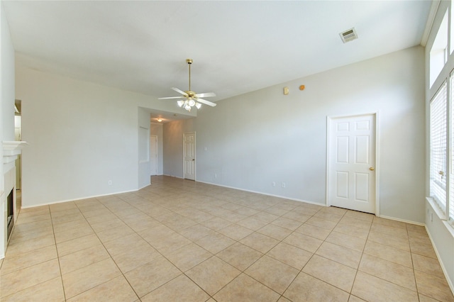 19814 Lindenfield Pl, Katy, TX 77449 - unfurnished living room with ceiling fan, a fireplace, and light tile patterned floors
