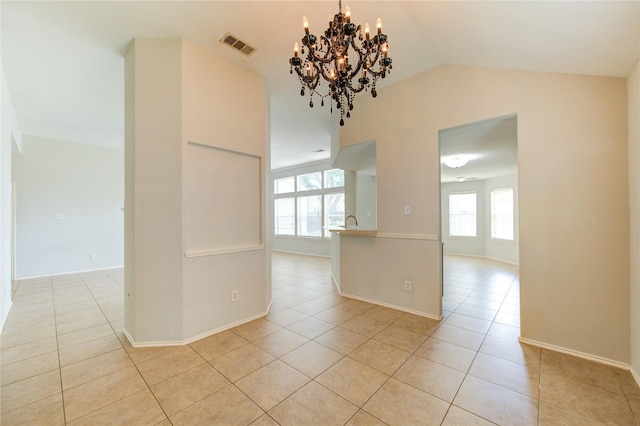 19814 Lindenfield Pl, Katy, TX 77449 - unfurnished room with light tile patterned floors, healthy amount of natural light, lofted ceiling, and a chandelier