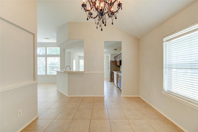 19814 Lindenfield Pl, Katy, TX 77449 - empty room featuring a chandelier, light tile patterned floors, lofted ceiling, baseboards, and a sink