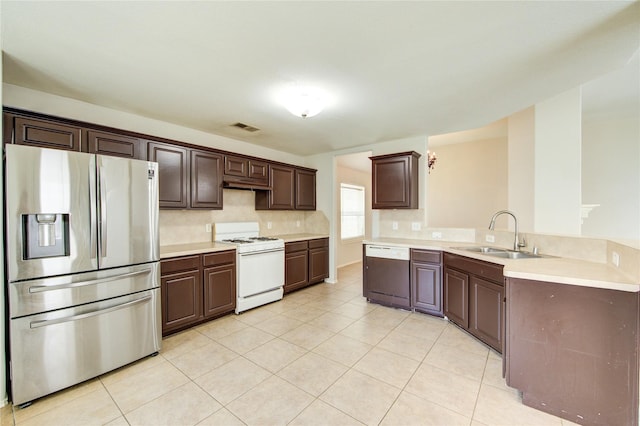 19814 Lindenfield Pl, Katy, TX 77449 - kitchen featuring stainless steel refrigerator with ice dispenser, white gas range oven, dishwashing machine, a sink, and a peninsula
