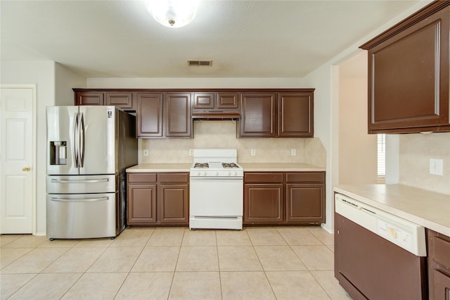 19814 Lindenfield Pl, Katy, TX 77449 - kitchen with stainless steel fridge with ice dispenser, gas range gas stove, under cabinet range hood, and light countertops