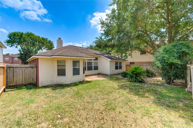 19814 Lindenfield Pl, Katy, TX 77449 - rear view of house featuring a chimney