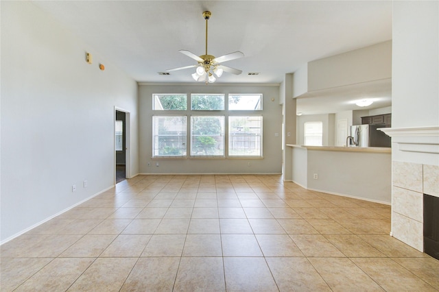 19814 Lindenfield Pl, Katy, TX 77449 - unfurnished living room with ceiling fan, light tile patterned floors, and baseboards