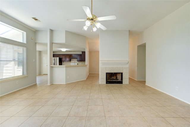 19814 Lindenfield Pl, Katy, TX 77449 - unfurnished living room with plenty of natural light, a tile fireplace, light tile patterned floors, and ceiling fan