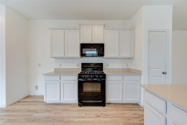 22619 Malvicino Dr, New Caney, TX 77357 - kitchen with black appliances, light countertops, and white cabinets