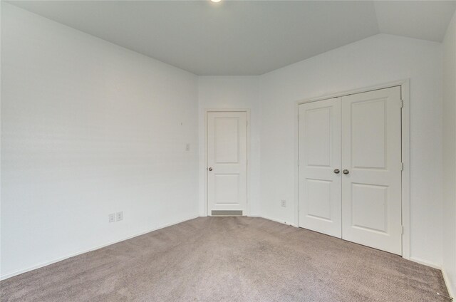 22619 Malvicino Dr, New Caney, TX 77357 - unfurnished bedroom with carpet flooring, a closet, and vaulted ceiling