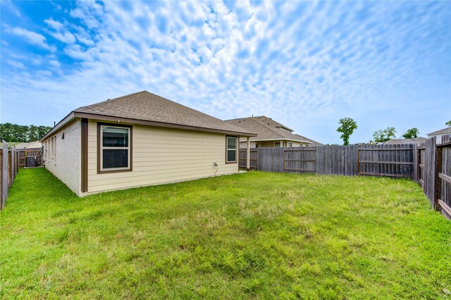 22619 Malvicino Dr, New Caney, TX 77357 - back of property featuring central AC and brick siding