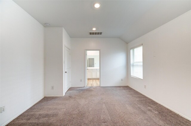 22619 Malvicino Dr, New Caney, TX 77357 - carpeted empty room with baseboards, lofted ceiling, recessed lighting, and a smoke detector