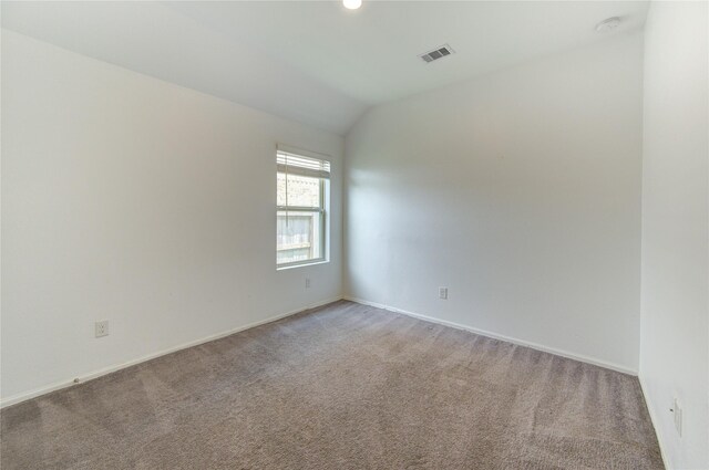 22619 Malvicino Dr, New Caney, TX 77357 - empty room with light carpet, lofted ceiling, baseboards, and a smoke detector