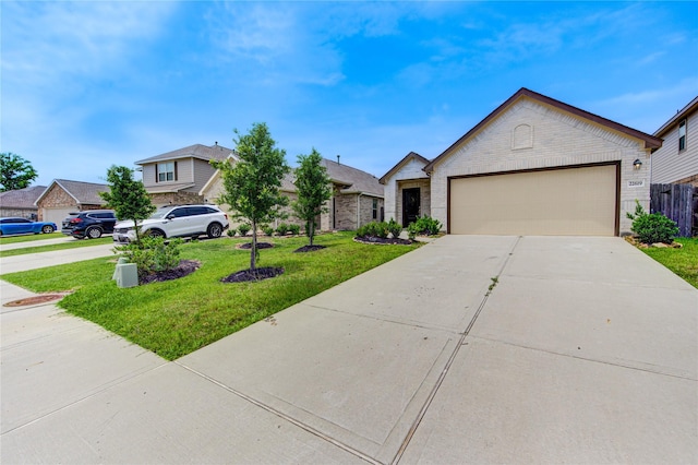 22619 Malvicino Dr, New Caney, TX 77357 - view of front facade with concrete driveway, brick siding, and an attached garage