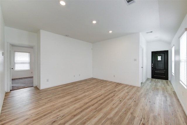 22619 Malvicino Dr, New Caney, TX 77357 - empty room featuring light wood finished floors, vaulted ceiling, and recessed lighting