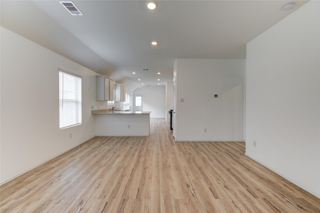 22619 Malvicino Dr, New Caney, TX 77357 - unfurnished living room featuring light wood-style floors, recessed lighting, baseboards, and a sink