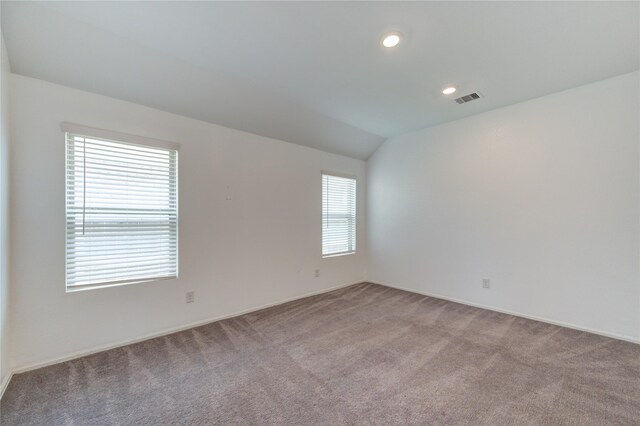 22619 Malvicino Dr, New Caney, TX 77357 - spare room with light colored carpet, baseboards, recessed lighting, and lofted ceiling