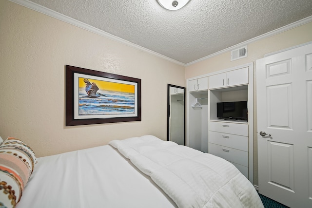 6102 Seawall Blvd Unit 175, Galveston, TX 77551 - bedroom with a textured ceiling, ornamental molding, and a closet