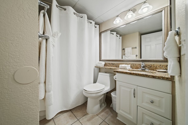 6102 Seawall Blvd Unit 175, Galveston, TX 77551 - bathroom featuring tile patterned flooring, vanity, toilet, curtained shower, and a drop ceiling