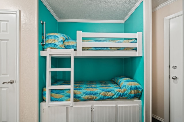 6102 Seawall Blvd Unit 175, Galveston, TX 77551 - bedroom featuring crown molding and a textured ceiling