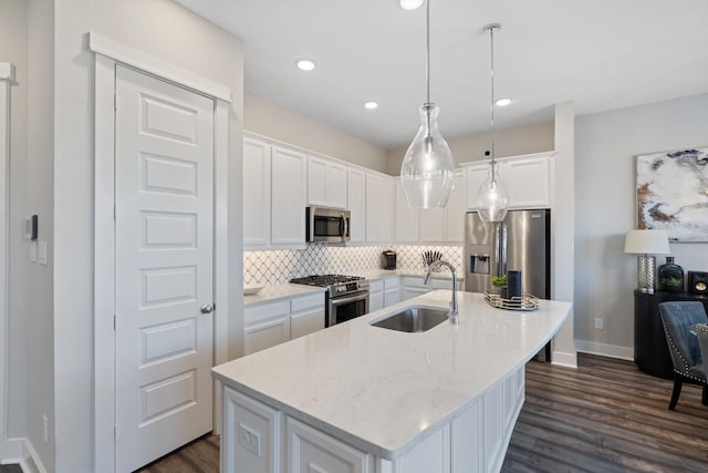 962 Ford Pines Ln, Houston, TX 77091 - kitchen featuring a sink, appliances with stainless steel finishes, tasteful backsplash, white cabinets, and dark wood-style flooring