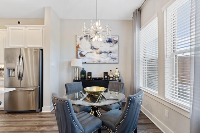 962 Ford Pines Ln, Houston, TX 77091 - dining space featuring a chandelier, wood finished floors, and baseboards