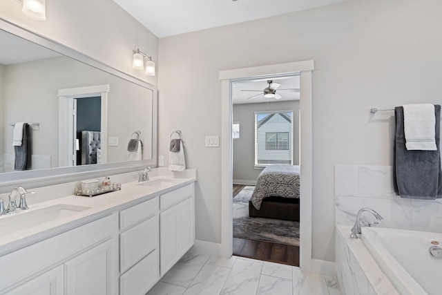 962 Ford Pines Ln, Houston, TX 77091 - full bath with baseboards, double vanity, marble finish floors, a garden tub, and a ceiling fan