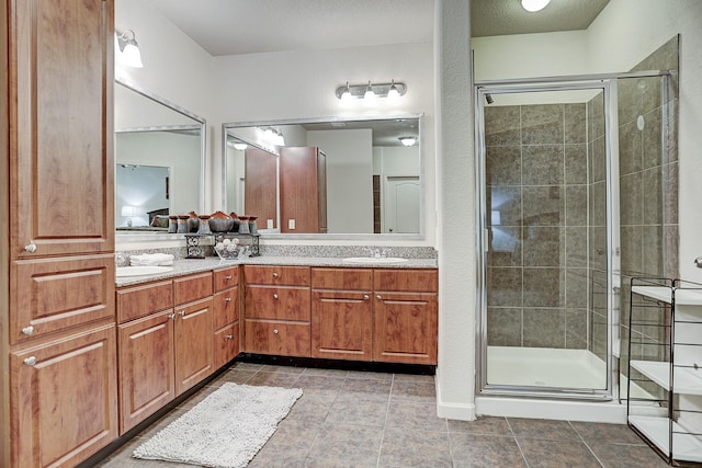 1711 Old Spanish Trl Unit 438, Houston, TX 77054 - bathroom featuring double vanity, a stall shower, and tile patterned floors