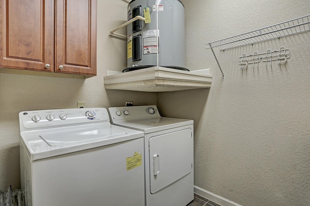 1711 Old Spanish Trl Unit 438, Houston, TX 77054 - laundry room featuring electric water heater, washing machine and dryer, cabinet space, and baseboards