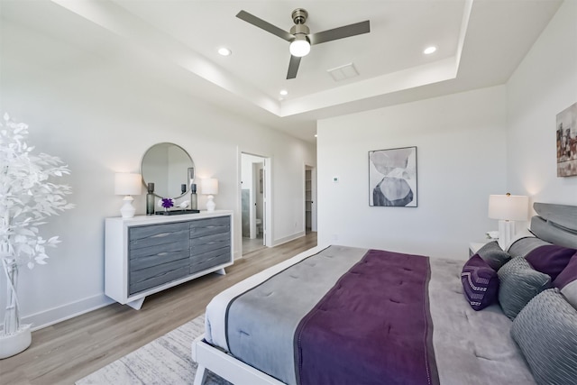 4917 Randon Rd, Houston, TX 77092 - bedroom featuring light wood-style flooring, recessed lighting, ceiling fan, a raised ceiling, and baseboards