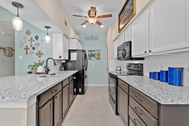 1881 Bering Dr Unit 25, Houston, TX 77057 - kitchen with black appliances, a sink, a peninsula, ceiling fan, and decorative backsplash