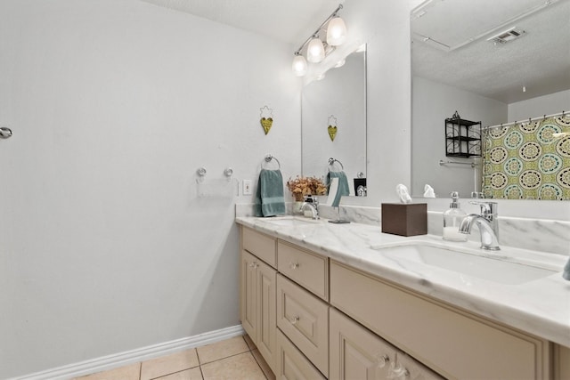 1881 Bering Dr Unit 25, Houston, TX 77057 - bathroom with double vanity, tile patterned flooring, and baseboards