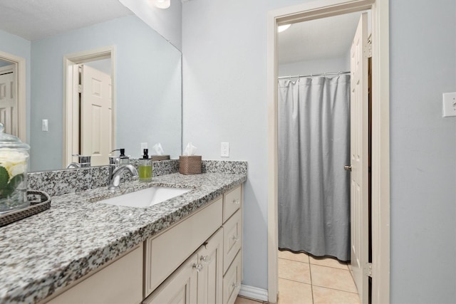 1881 Bering Dr Unit 25, Houston, TX 77057 - full bathroom with vanity, tile patterned floors, a shower with curtain, and baseboards