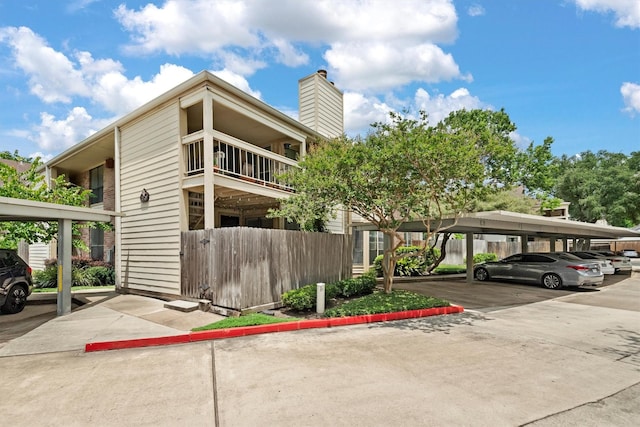 1881 Bering Dr Unit 25, Houston, TX 77057 - view of property exterior with covered parking and a chimney