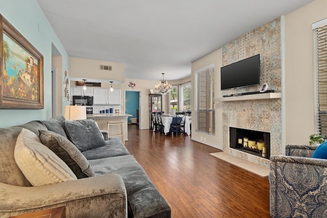 1881 Bering Dr Unit 25, Houston, TX 77057 - living area with a chandelier, dark wood finished floors, and a high end fireplace