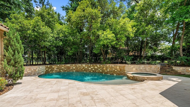 10 Maroon Creek Ct, Spring, TX 77389 - view of pool featuring a pool with connected hot tub, a patio, and view of wooded area