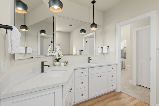 5809 Francis Oak Pl, Houston, TX 77091 - bathroom featuring double vanity and wood finished floors