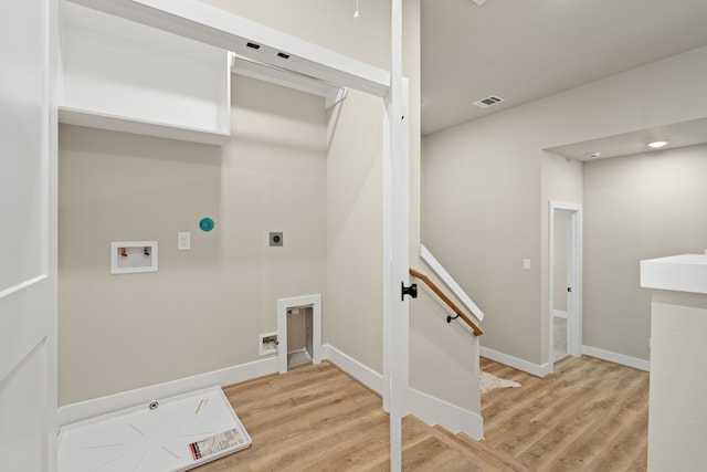 5809 Francis Oak Pl, Houston, TX 77091 - washroom with hookup for an electric dryer, washer hookup, light wood-style flooring, and baseboards