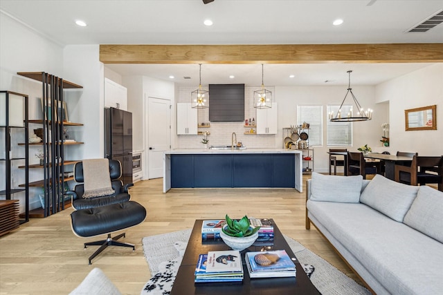 507 Leverkuhn St, Houston, TX 77007 - living room featuring beamed ceiling, light wood-style floors, recessed lighting, and a chandelier