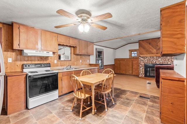 3840 N Fm 356, Onalaska, TX 77360 - kitchen with electric range, under cabinet range hood, wooden walls, a textured ceiling, and vaulted ceiling