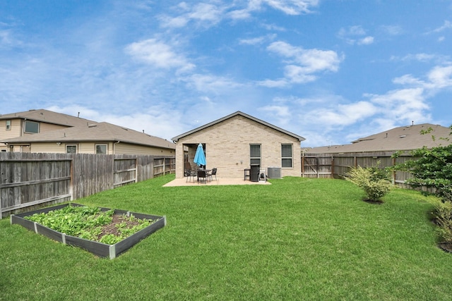 13003 Mills Creek Meadow Dr, Houston, TX 77070 - back of house with a vegetable garden, a patio, central AC unit, and brick siding