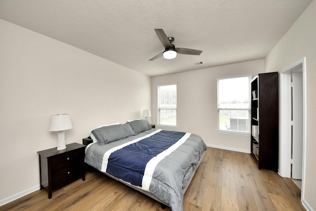 13003 Mills Creek Meadow Dr, Houston, TX 77070 - bedroom featuring light wood-style flooring, baseboards, and ceiling fan