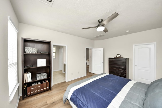 13003 Mills Creek Meadow Dr, Houston, TX 77070 - bedroom with light wood-type flooring, baseboards, and a ceiling fan