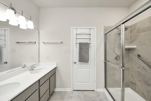 13003 Mills Creek Meadow Dr, Houston, TX 77070 - bathroom with double vanity, a shower stall, baseboards, and tile patterned floors