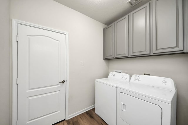 13003 Mills Creek Meadow Dr, Houston, TX 77070 - laundry area featuring cabinet space, washing machine and clothes dryer, dark wood-style floors, and baseboards