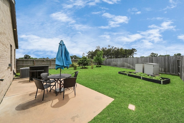 13003 Mills Creek Meadow Dr, Houston, TX 77070 - view of yard featuring a vegetable garden, a patio area, outdoor dining space, and cooling unit
