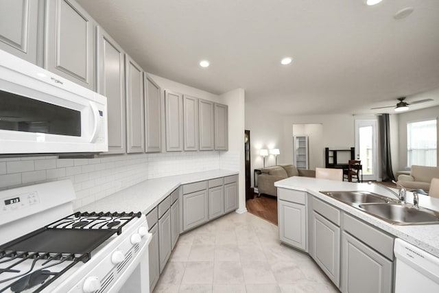 13003 Mills Creek Meadow Dr, Houston, TX 77070 - kitchen featuring white appliances, gray cabinetry, open floor plan, a sink, and recessed lighting