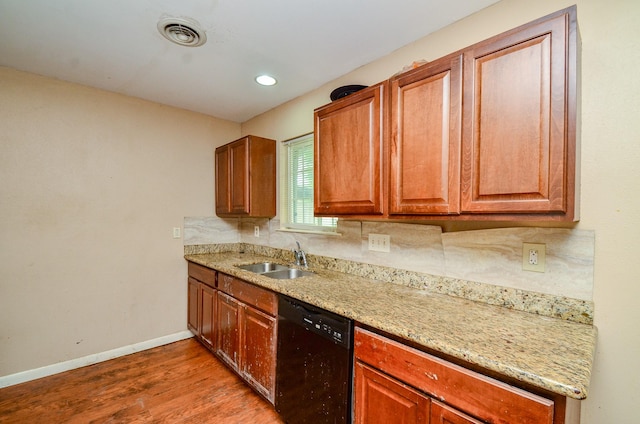 5914 Newquay St, Houston, TX 77085 - kitchen featuring black dishwasher, a sink, baseboards, wood finished floors, and light stone counters