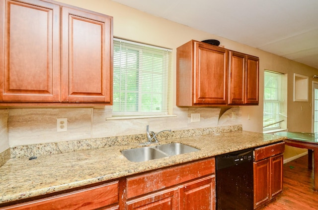 5914 Newquay St, Houston, TX 77085 - kitchen with dishwasher, a sink, light wood-type flooring, light stone countertops, and brown cabinets