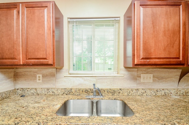 5914 Newquay St, Houston, TX 77085 - kitchen featuring a sink, decorative backsplash, and light stone countertops