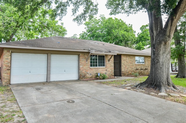 5914 Newquay St, Houston, TX 77085 - ranch-style home featuring brick siding, roof with shingles, and driveway