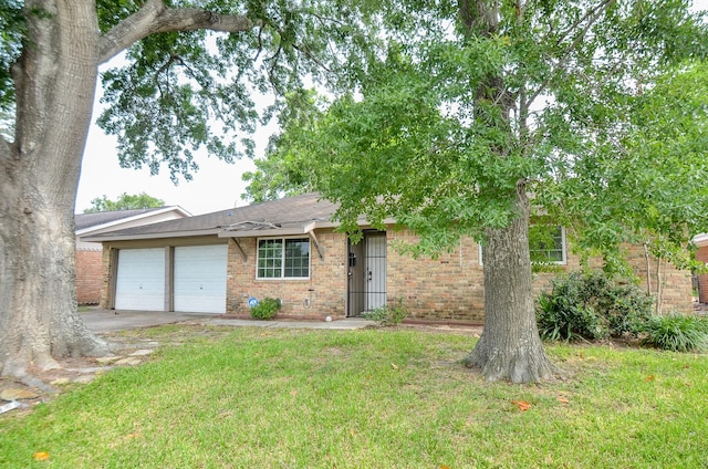 5914 Newquay St, Houston, TX 77085 - view of front of property with brick siding, a garage, a front lawn, and concrete driveway