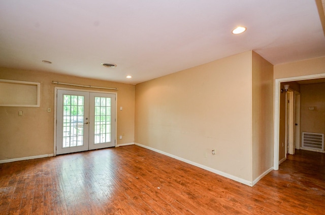 5914 Newquay St, Houston, TX 77085 - empty room featuring baseboards, wood finished floors, french doors, and recessed lighting
